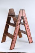 A PAIR OF NOVELTY WOODEN CHAMPAGNE STEPLADDERS. 80cms high.