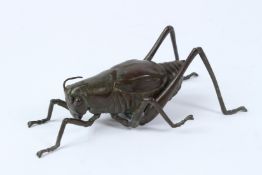 A FINE JAPANESE OKIMONO BRONZE GRASSHOPPER with articulated legs. 18cms long.