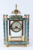 A DECORATIVE CLOISONNE AND GILT BRASS MANTLE CLOCK, with painted dial. 46cms high x 32cms wide.