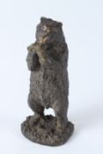 A BRONZE FIGURE OF A STANDING BEAR eating a bunch of grapes. 28cms high.