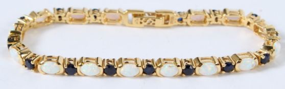 A SILVER AND 18CT GOLD PLATED OPAL AND SAPPHIRE BRACELET.