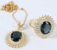 A SILVER AND GOLD PLATED BLUE TOPAZ RING AND PENDANT.