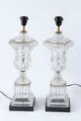 A PAIR OF GLASS URN SHAPED TABLE LAMPS, on square marble bases. 58cms high.