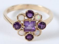 A 9CT GOLD AMETHYST AND OPAL RING.