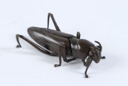 A JAPANAESE BRONZE ARTICULATED LOCUST. 8cms.