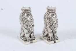 A SILVER PLATED ROYAL LION SALT AND PEPPERS.