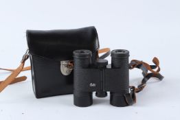 A PAIR OF LEITZ BINOCULARS in a black leather case.