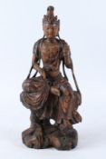 A LARGE LACQUER WOOD FIGURE OF GUANYIN, Qing Dynasty (1644 - 1912), modelled seated wearing