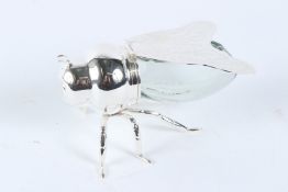 A SILVER PLATE AND GLASS HONEY POT IN THE FORM OF A BEE. 15cms long.