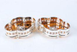 A PAIR OF PLATE AND FAUX TORTOISESHELL WINE COASTERS.