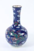 A CHINESE BLUE DRAGON VASE with dragons and clouds. 24cms high.
