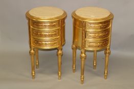A PAIR OF GILTWOOD CIRCULAR THREE DRAWER BEDSIDE TABLES, with cream marble tops. 2ft 3ins high x 1ft