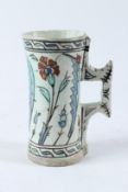 A FINE EARLY 17TH CENTURY OTTOMAN TURKISH IZNIK TANKARD. 19.5cms high.