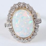 A 9CT GOLD OPAL AND DIAMOND RING.