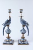 A PAIR OF BLUE AND WHITE PORCELAIN PARROT CANDLESTICKS, with ormolu mounts, on square bases. 49cms