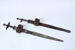 TWO NORTH AFRICAN TUBANG TAKOUBA SWORDS. 70cms long.