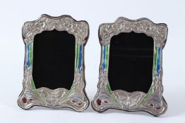 A PAIR OF SILVER AND ENAMEL PHOTOGRAPH FRAMES decorated with butterflies. 21cms high.