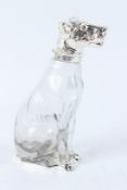 A CLEAR GLASS DOG SHAPED CLARET JUG WITH PLATED MOUNTS. 25cms high.