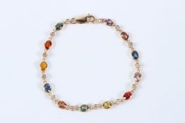 AN 18CT YELLOW GOLD MULTI-COLOURED SAPPHIRE AND DIAMOND BRACELET.