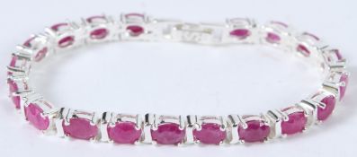 A SILVER AND RUBY TENNIS BRACELET.