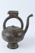 A FINELY ENGRAVED PERSIAN BRONZE KETTLE SHAPED EWER. 27cms high.
