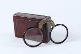 AN EARLY PAIR OF FOLDING SPECTACLES in a wooden case. Spectacles 12.5cms wide.