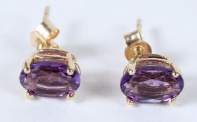 A PAIR OF 9CT GOLD OVAL AMETHYST STUD EARRINGS.