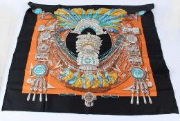 HERMES, PARIS, a silk scarf with Mayan decoration, in original envelope. 87cms x 87cms.