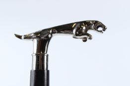 A WALKING STICK, THE HANDLE MODELLED AS A JAGUAR CAR MASCOT.