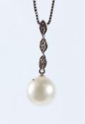 AN 18CT WHITE GOLD, DIAMOND AND PEARL PENDANT AND CHAIN. Chain 40cms long.