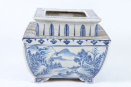 A CHINESE BLUE AND WHITE LARGE SQUARE PLANTER with four landscape panels. 22cms square.