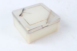 A GOOD ART DECO ONYX CIGARETTE BOX, with silver hine and mounts, the hinged cover inlaid with a
