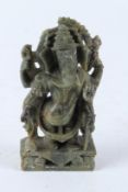 A 19TH CENTURY INDIAN CARVED GREEN STONE GANESH. 13cms high.
