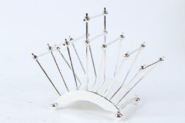 A CHRISTOPHER DRESSER STYLE PLATED TOAST RACK. 21cms wide.