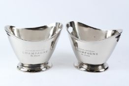 A PAIR OF POLISHED METAL TWIN HANDLE OVAL WINE COOLERS. 36cms wide.