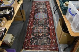 A Persian runner, worn, 286cm x 86cm.