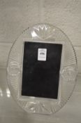 A Waterford cut glass photograph frame.