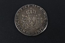 A French Louis XV coin, dated 1767.