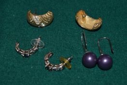 Three pairs of decorative earrings.