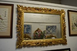 A decorative gilt framed rectangular mirror, 120cm x 90cm.