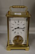 A brass carriage or dressing table clock.