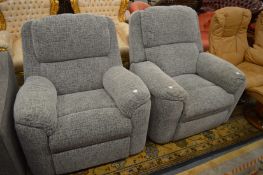 A pair of modern grey upholstered armchairs, one with electrically operated mechanism.
