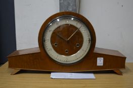 A walnut mantel clock.