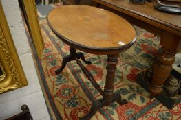 An Edwardian inlaid walnut stretcher table.