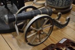 Cast iron model of a cannon.