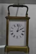 A small brass carriage clock.