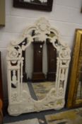 A large decoratively painted mirror of shaped outline, 168cm x 110cm.