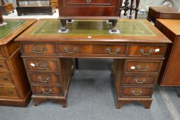 A reproduction mahogany pedestal desk.