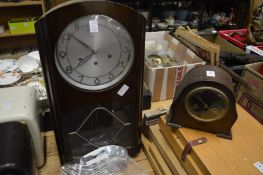 A wall clock and a mantel clock.