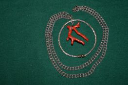 A coral and silver necklace.